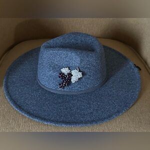 Grey fedora hat with a vintage grape cluster and clear pave rhinestones pin.